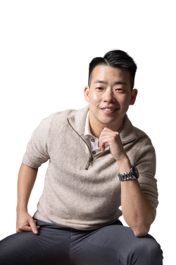 Emery Fung, smiling and leaning forward in a beige zip-neck jumper